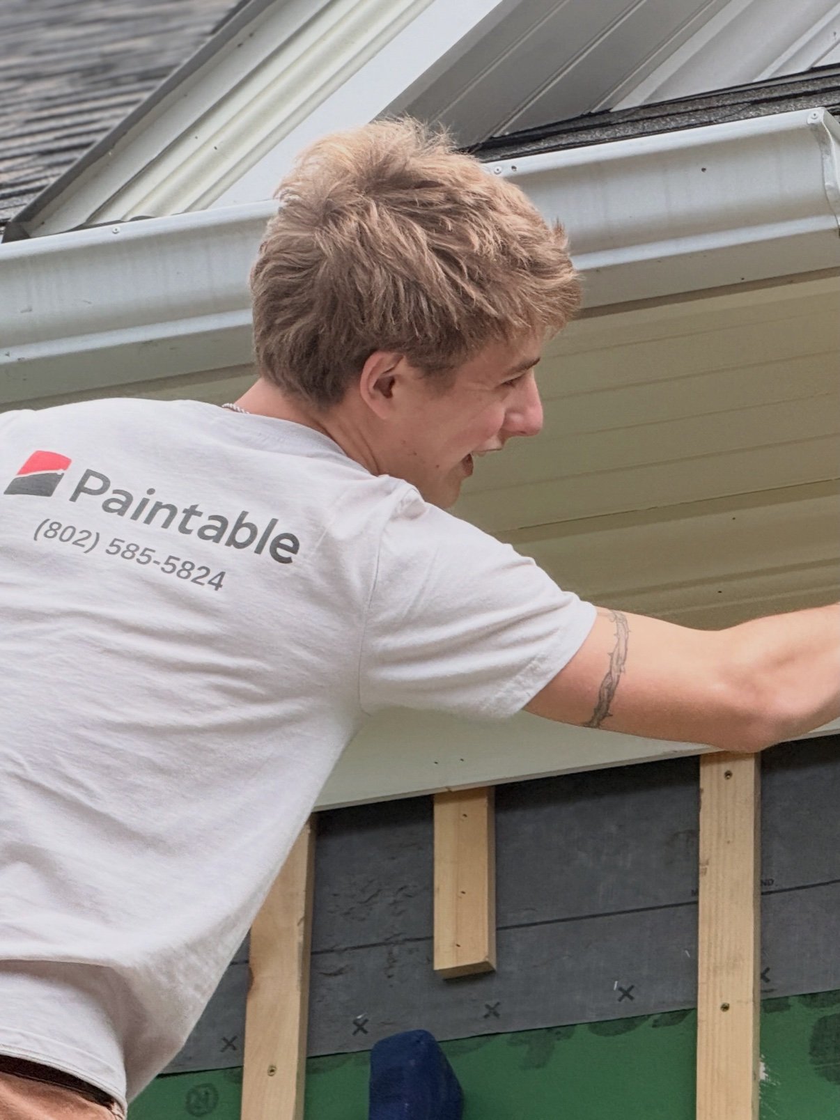 Paintable crew member painting an exterior wall